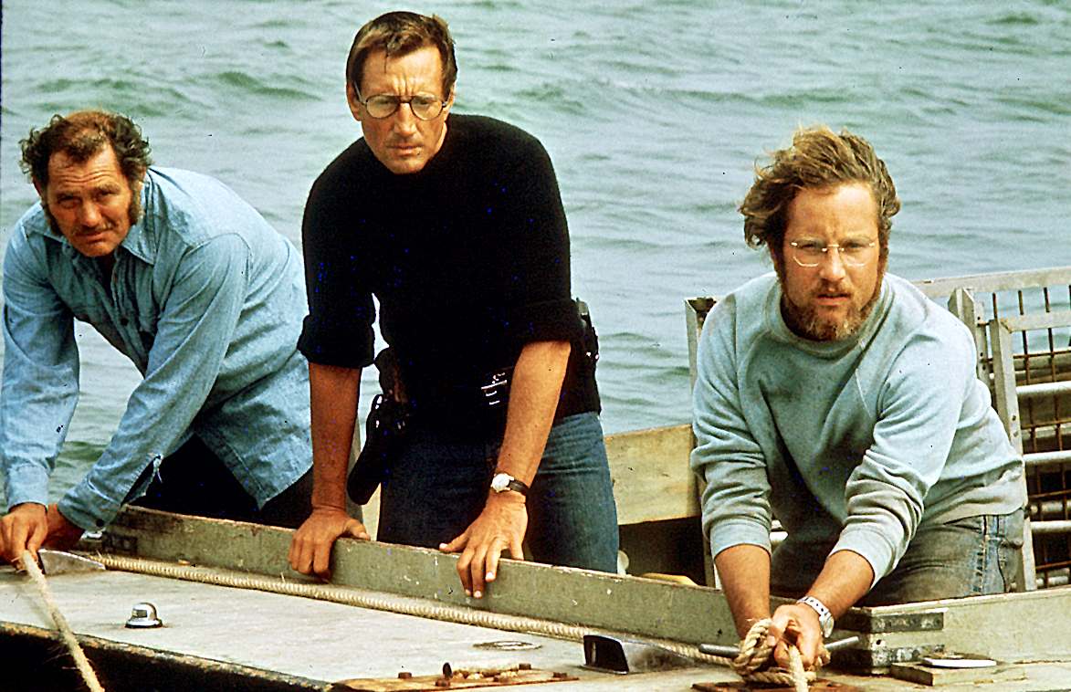 Captain Quint, Chief Brody and Matt Hooper watch Jaws pull their boat apart